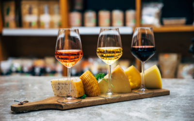 Wine bottles, glasses and cheese in restaurant